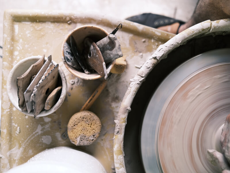 A messy pottery workstation for wheel throwing